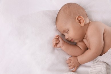 Photo of Cute little baby sleeping in bed, top view. Space for text