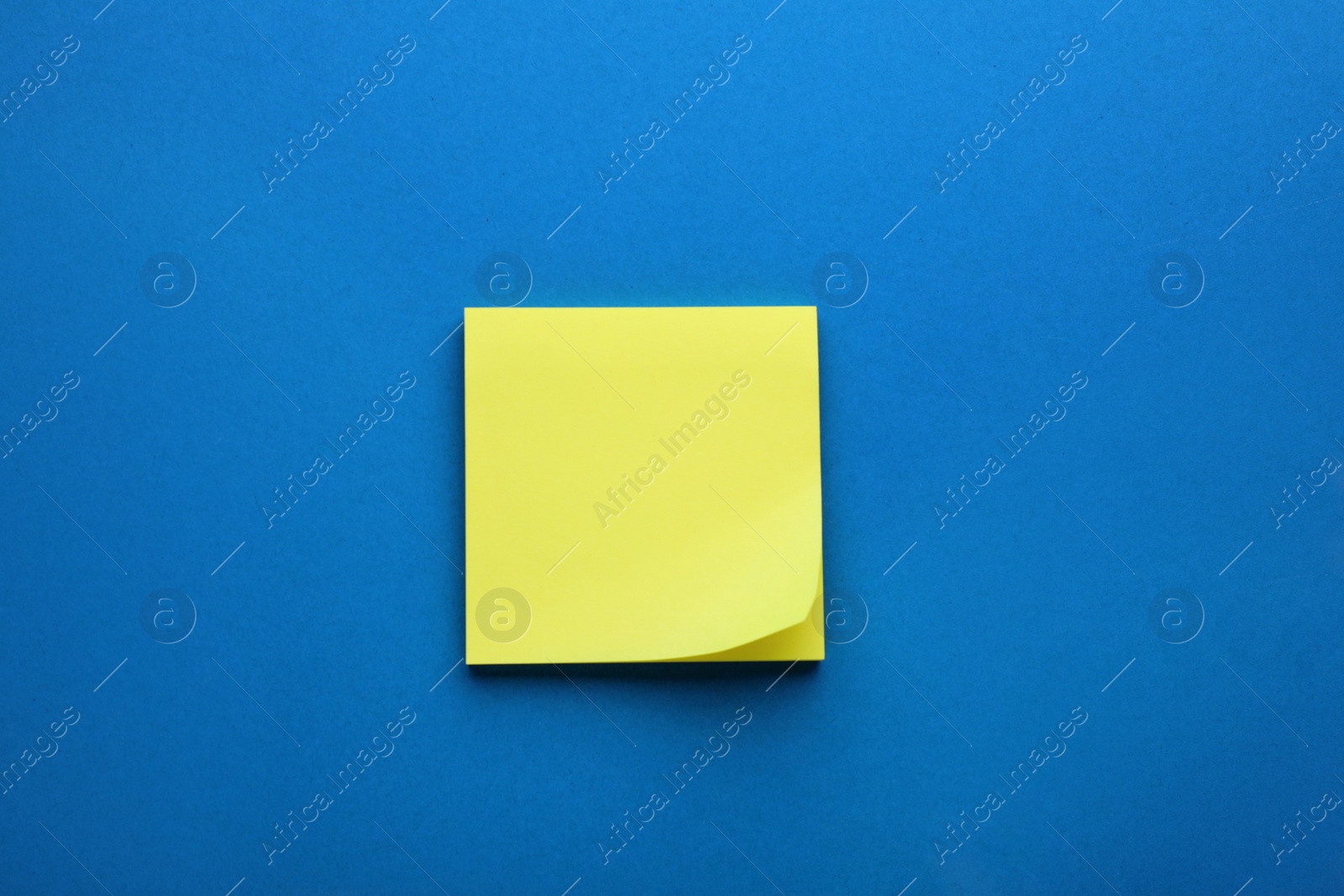 Photo of Paper note on blue background, top view
