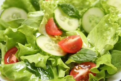 Photo of Delicious fresh salad in white bowl, closeup