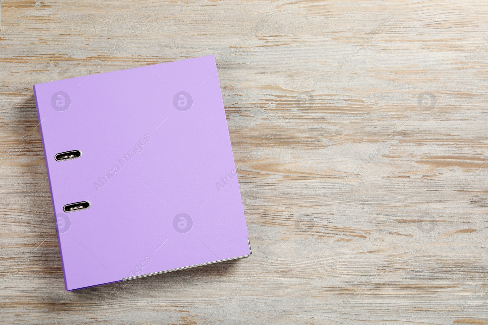 Photo of Lilac office folder on wooden table, top view