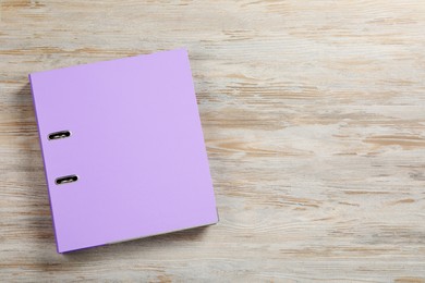 Lilac office folder on wooden table, top view