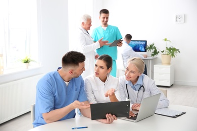 Group of doctors attending meeting in clinic. Cardiology conference