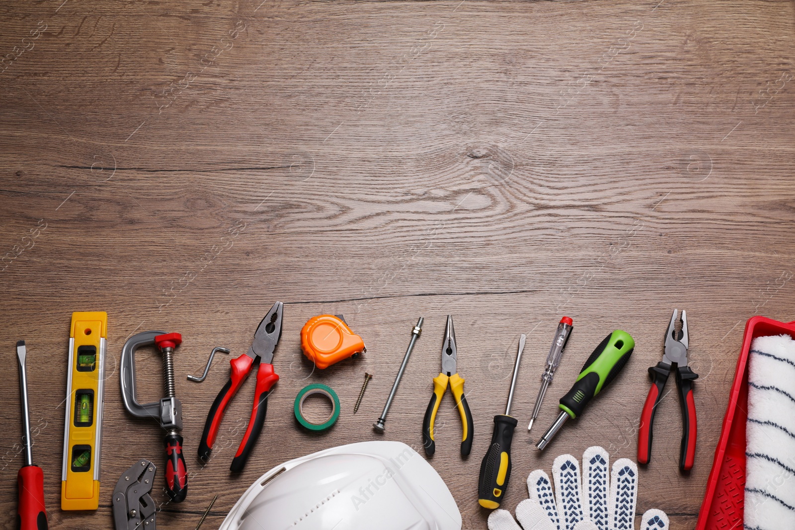 Photo of Flat lay composition with different construction tools on wooden background. Space for text