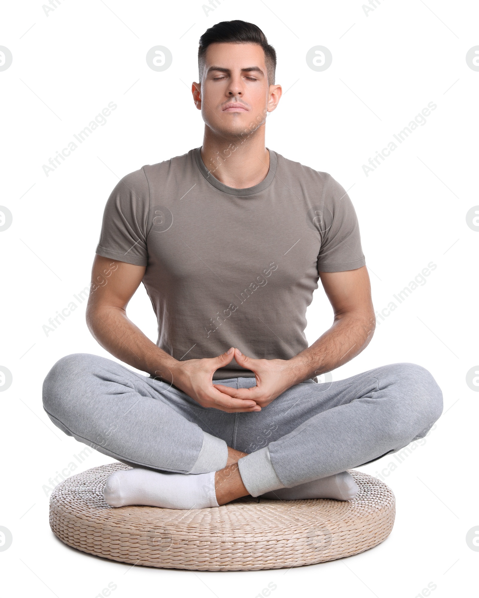 Photo of Handsome man meditating on white background. Harmony and zen