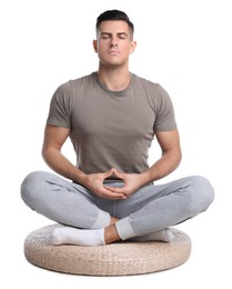 Photo of Handsome man meditating on white background. Harmony and zen