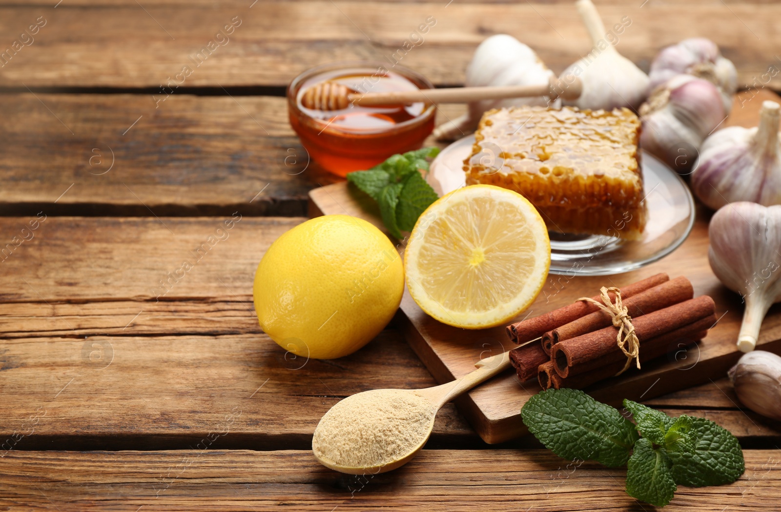 Photo of Different fresh products on wooden table, space for text. Natural antibiotics