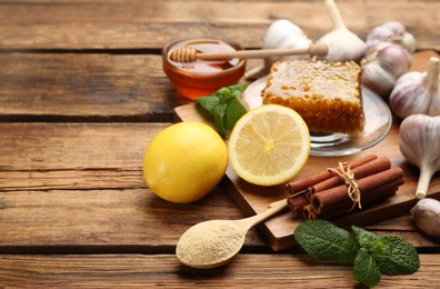 Photo of Different fresh products on wooden table, space for text. Natural antibiotics