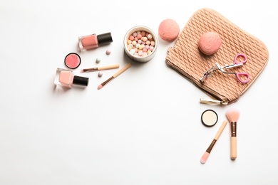 Makeup products with cosmetic bag on white background