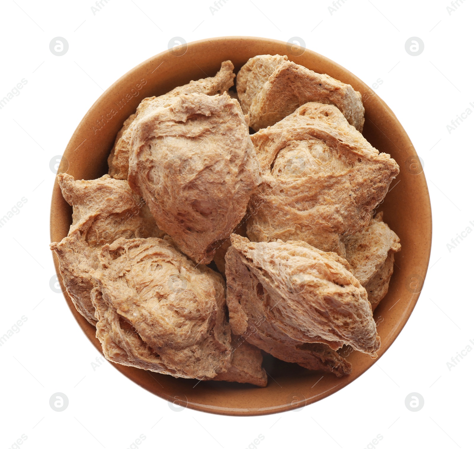 Photo of Dehydrated soy meat chunks in bowl on white background, top view