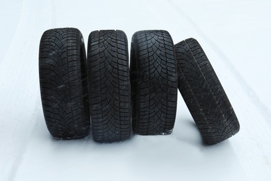 Photo of New winter tires on fresh snow outdoors