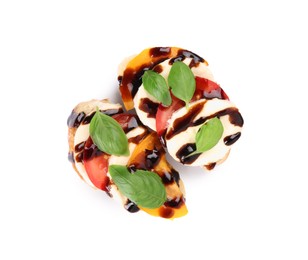 Photo of Delicious bruschettas with mozzarella cheese, tomatoes and balsamic vinegar isolated on white, top view