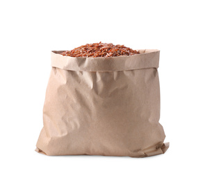 Photo of Brown rice in paper bag isolated on white