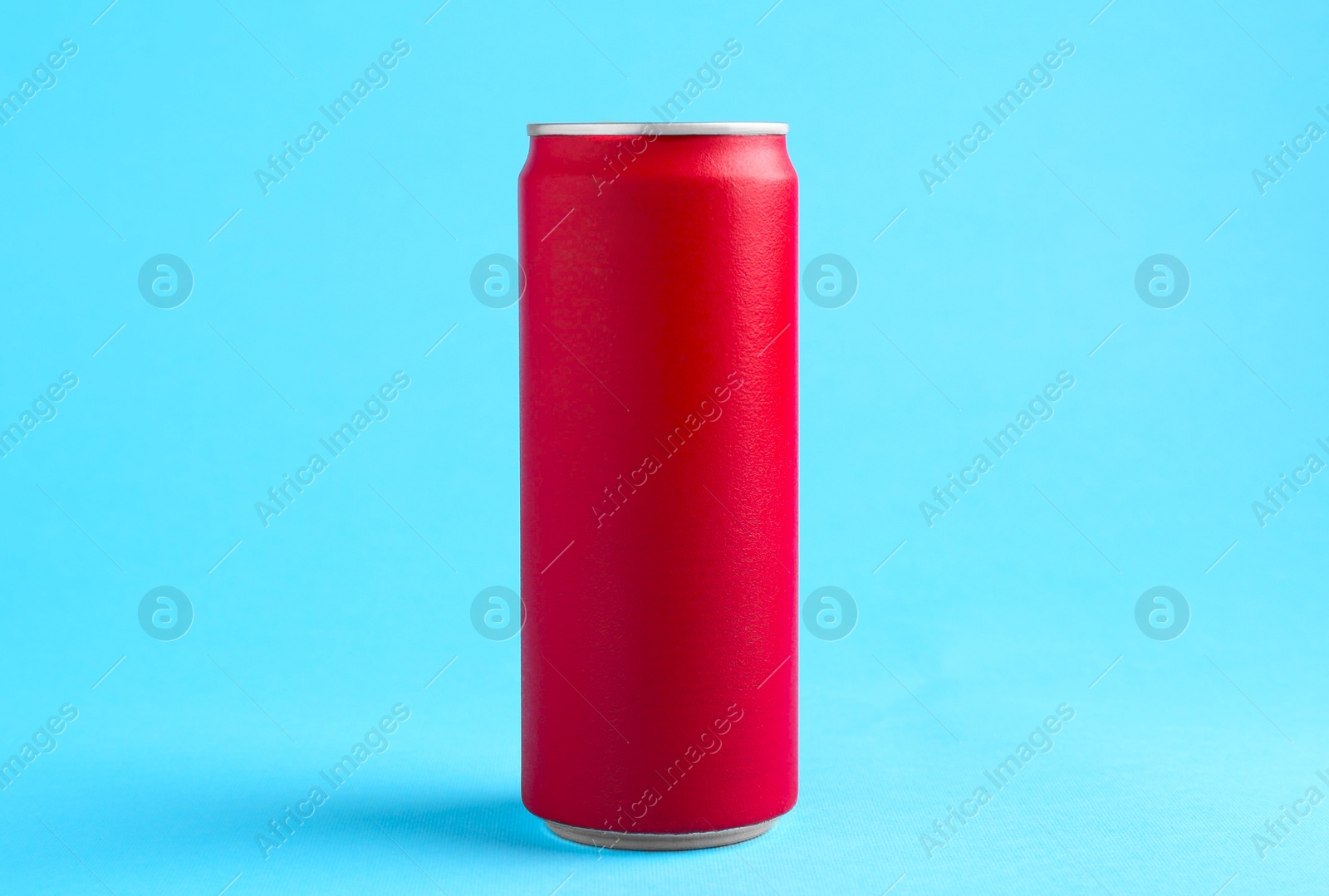 Photo of Energy drink in red can on light blue background