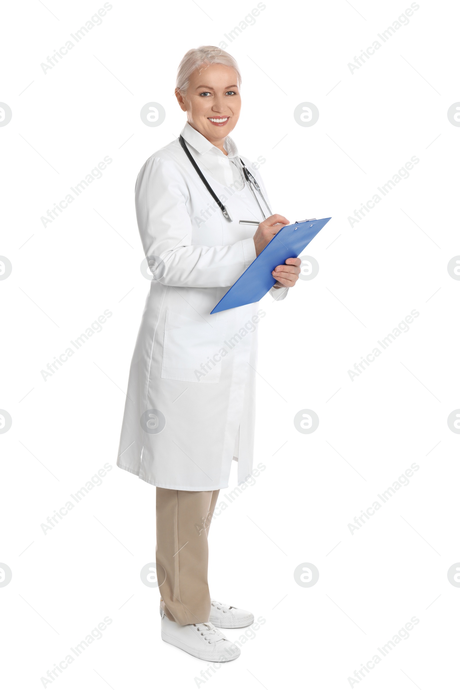 Photo of Mature doctor with clipboard on white background