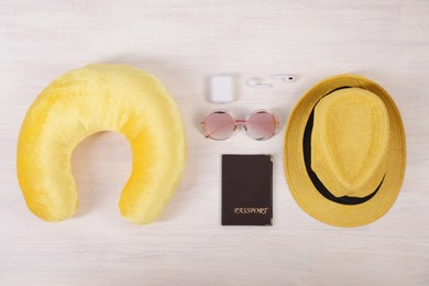 Photo of Flat lay composition with yellow travel pillow on white wooden background