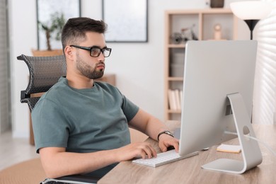 Programmer working with computer at desk in office