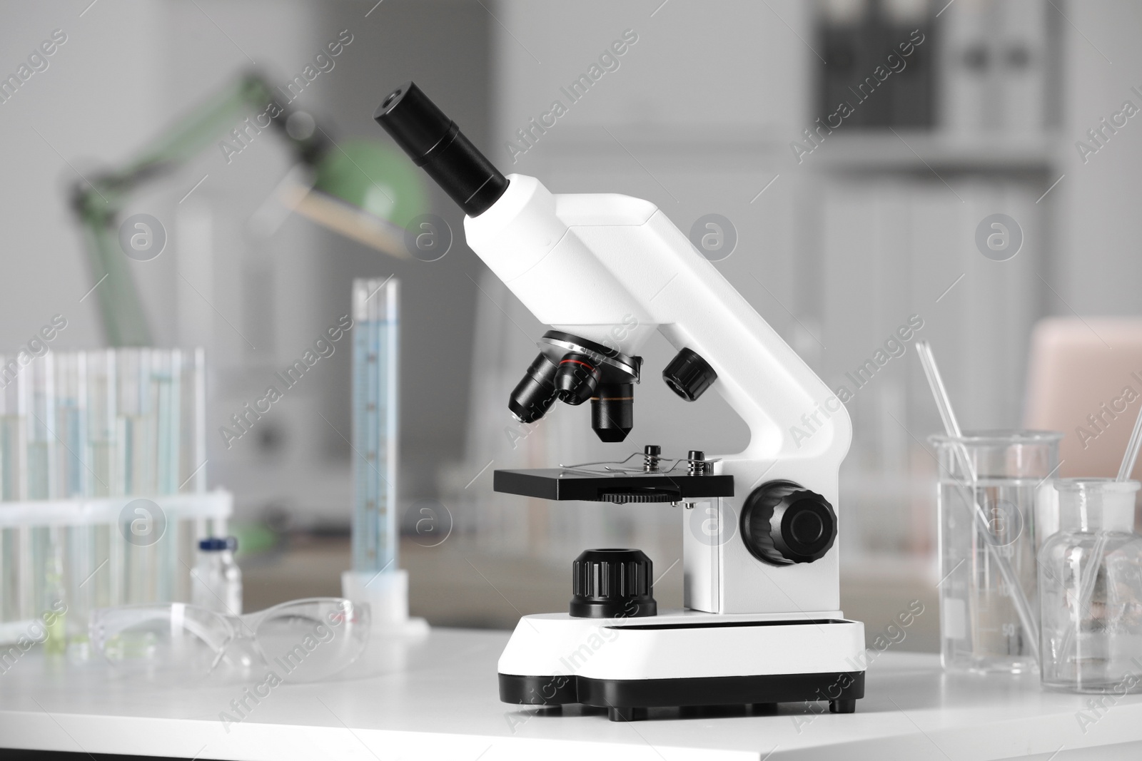 Photo of Modern medical microscope on white table in laboratory