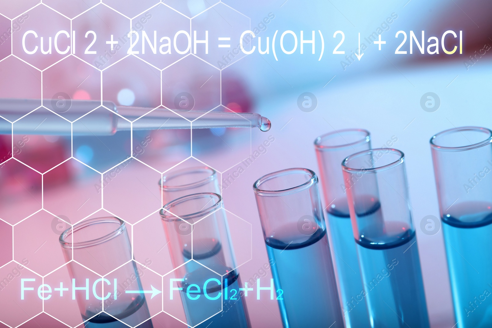 Image of Dripping reagent into test tube with blue liquid, closeup