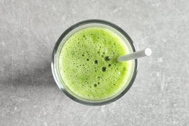 Glass with delicious detox juice on light background, top view