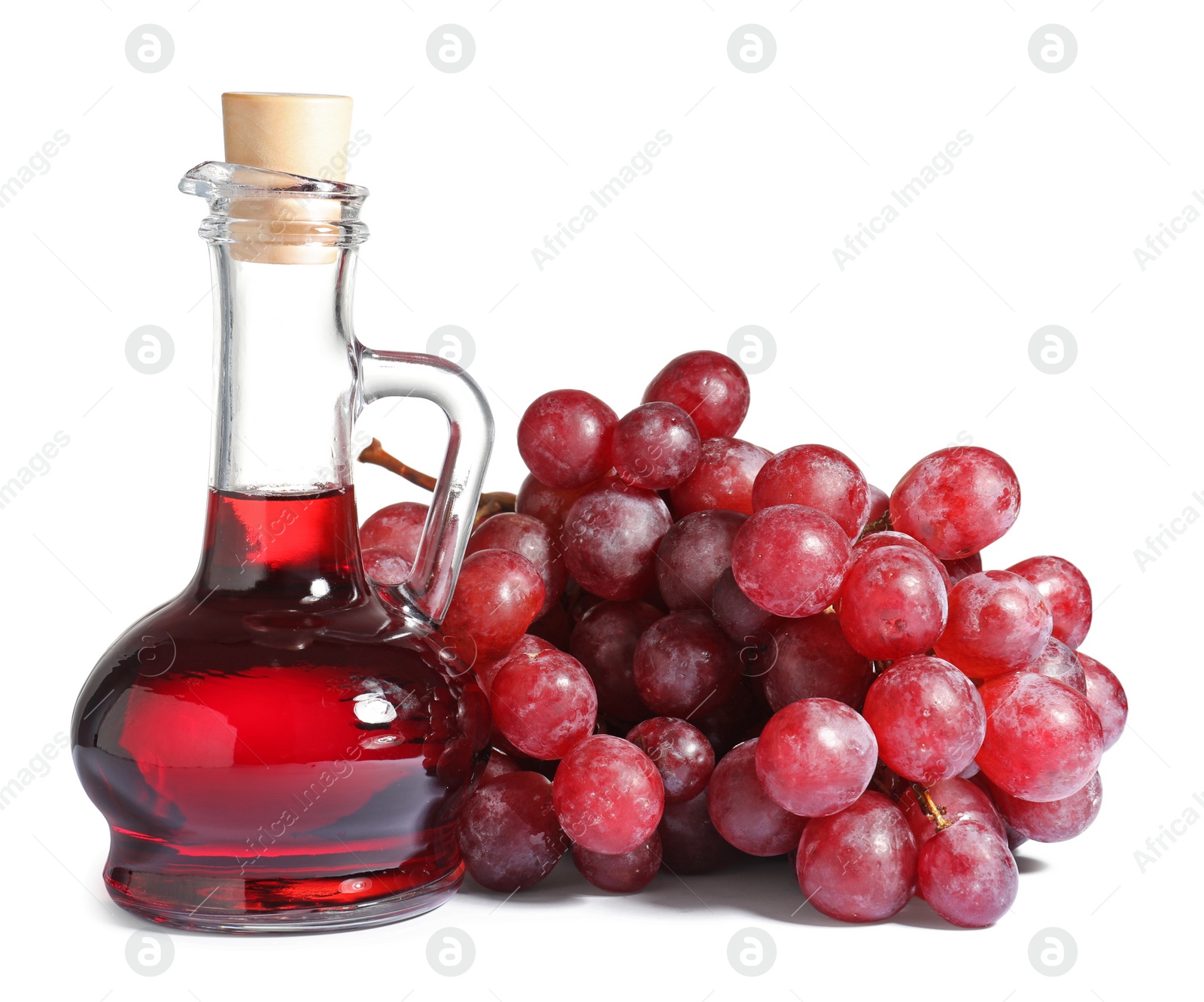 Photo of Glass jug with wine vinegar and fresh grapes on white background