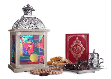 Photo of Decorative Arabic lantern, Quran, dates, baklava and coffee on white background