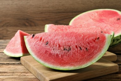 Photo of Slices of tasty ripe watermelon on wooden table