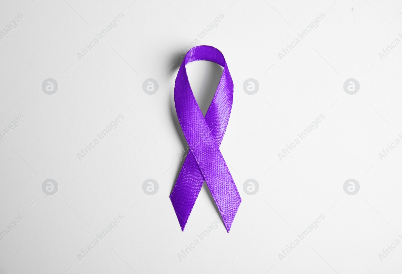 Photo of Purple ribbon on white background, top view. Domestic violence awareness