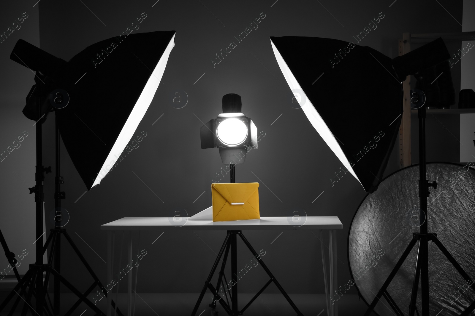 Photo of Professional photography equipment prepared for shooting stylish bag in studio