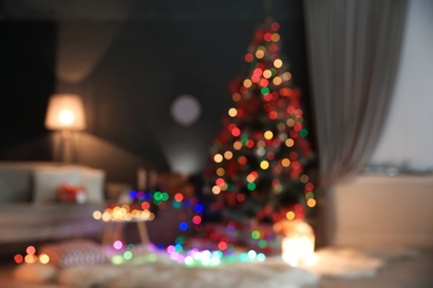 Photo of Blurred view of stylish room interior with decorated Christmas tree