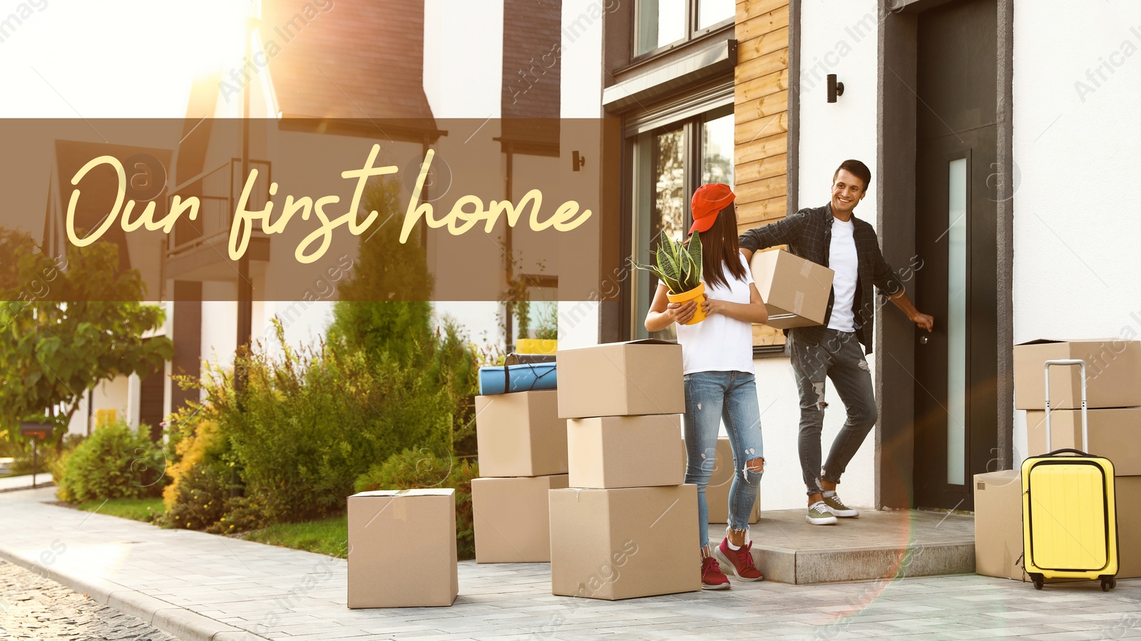 Image of First-time buyer. Happy couple with moving boxes and household stuff near their new house on sunny day and phrase Our First Home