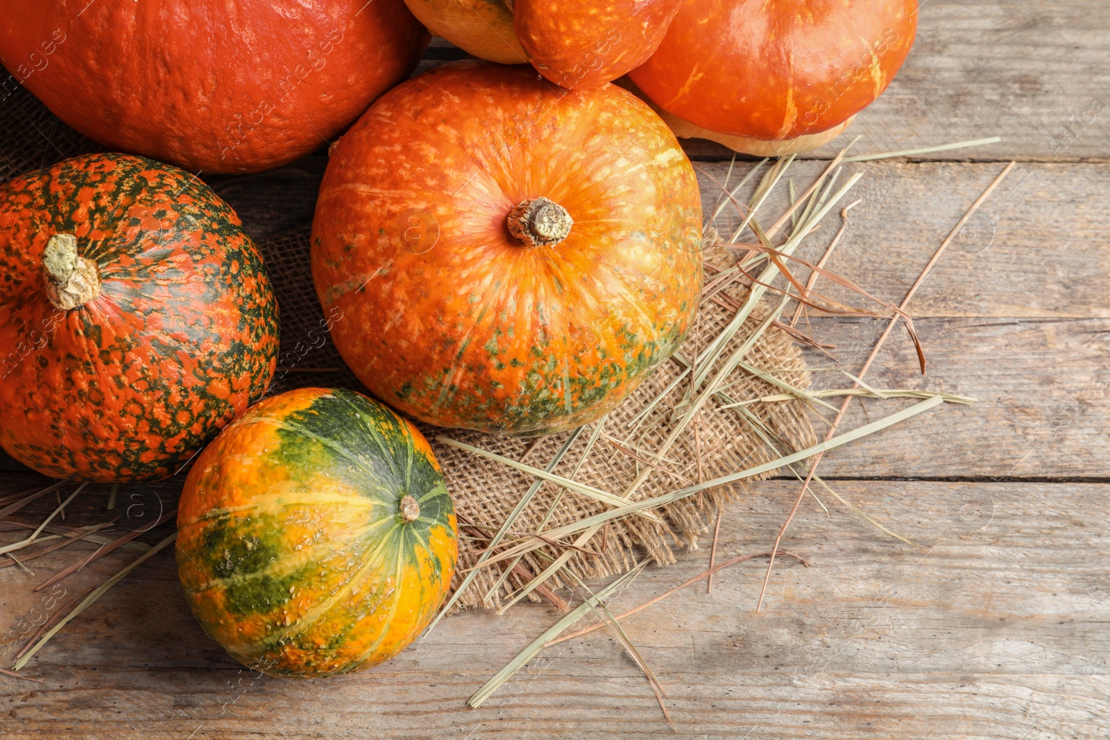 Photo of Flat lay composition with orange pumpkins on wooden background. Autumn holidays