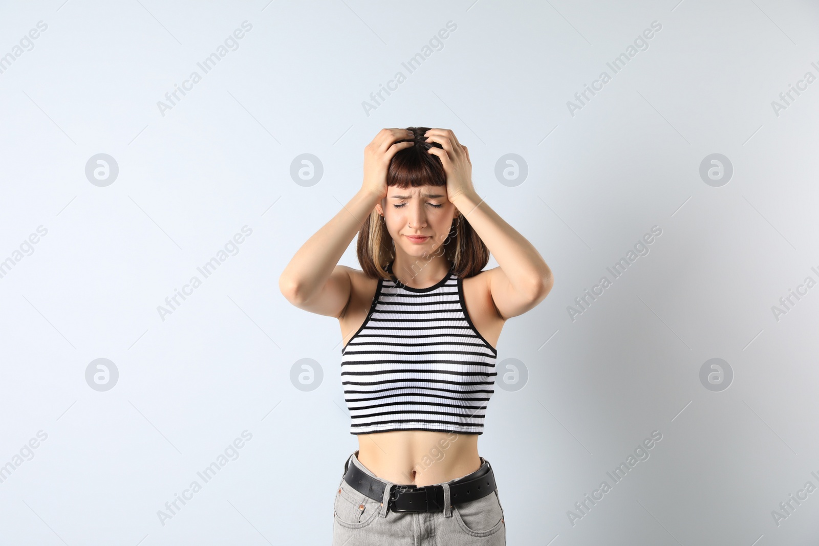 Photo of Portrait of unhappy young girl on white background