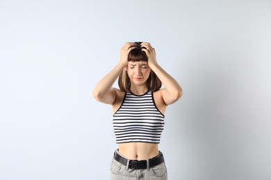 Photo of Portrait of unhappy young girl on white background