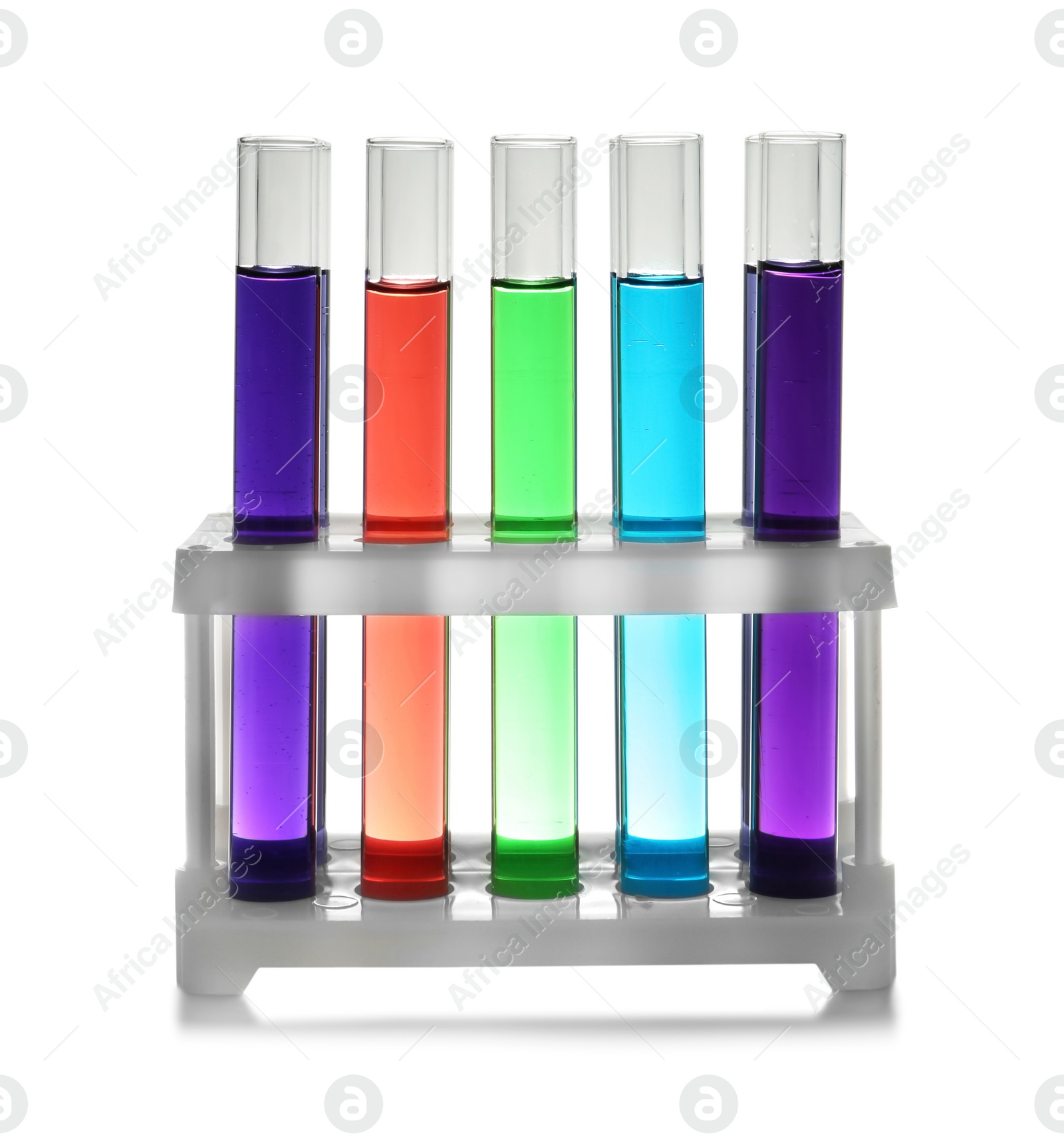 Photo of Rack with test tubes of color liquid isolated on white. Solution chemistry