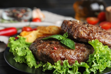 Photo of Grilled meat cutlets for burger on table, closeup