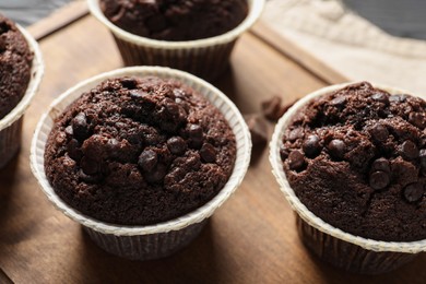 Delicious chocolate muffins on table, closeup view