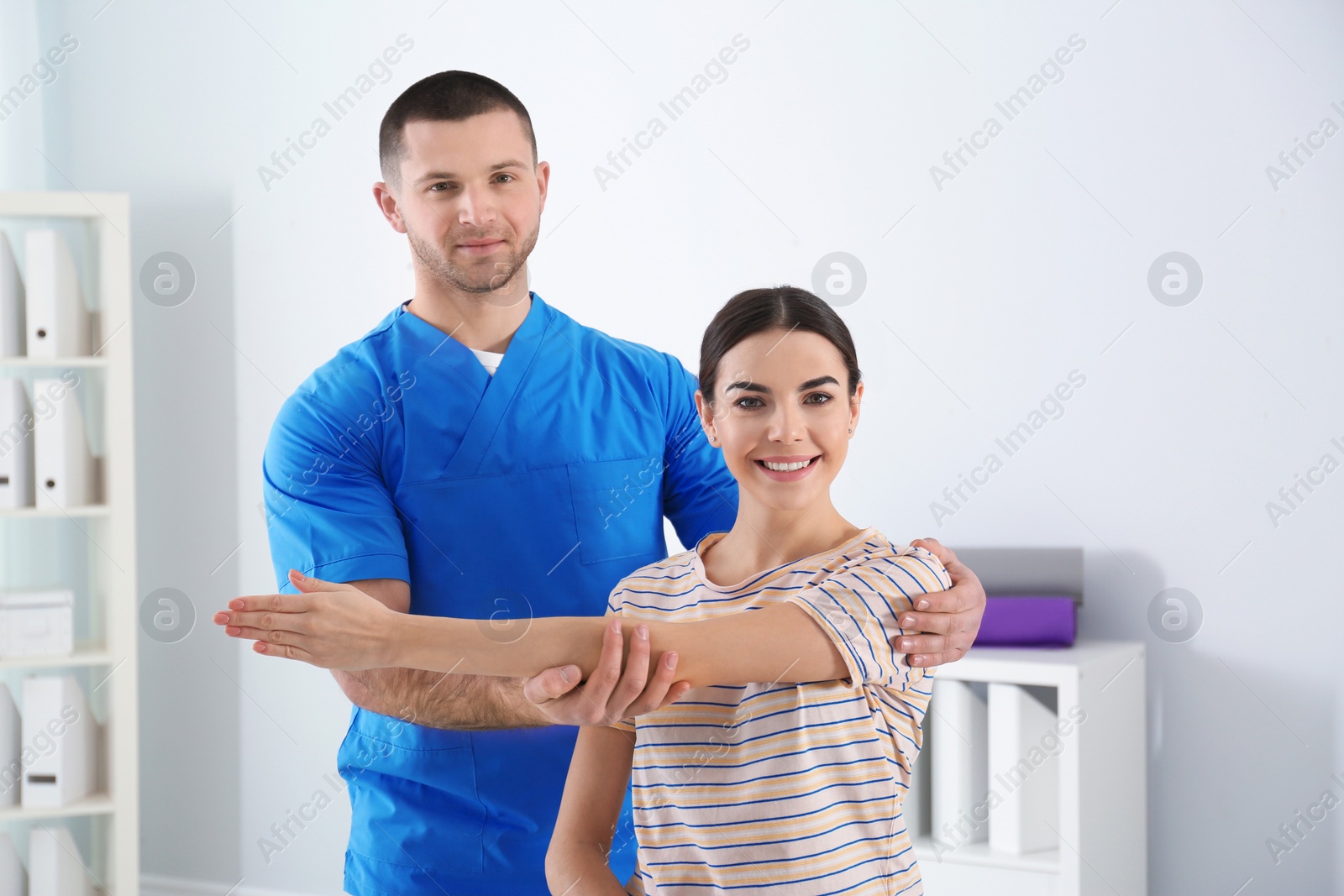 Photo of Doctor working with patient in hospital. Rehabilitation physiotherapy