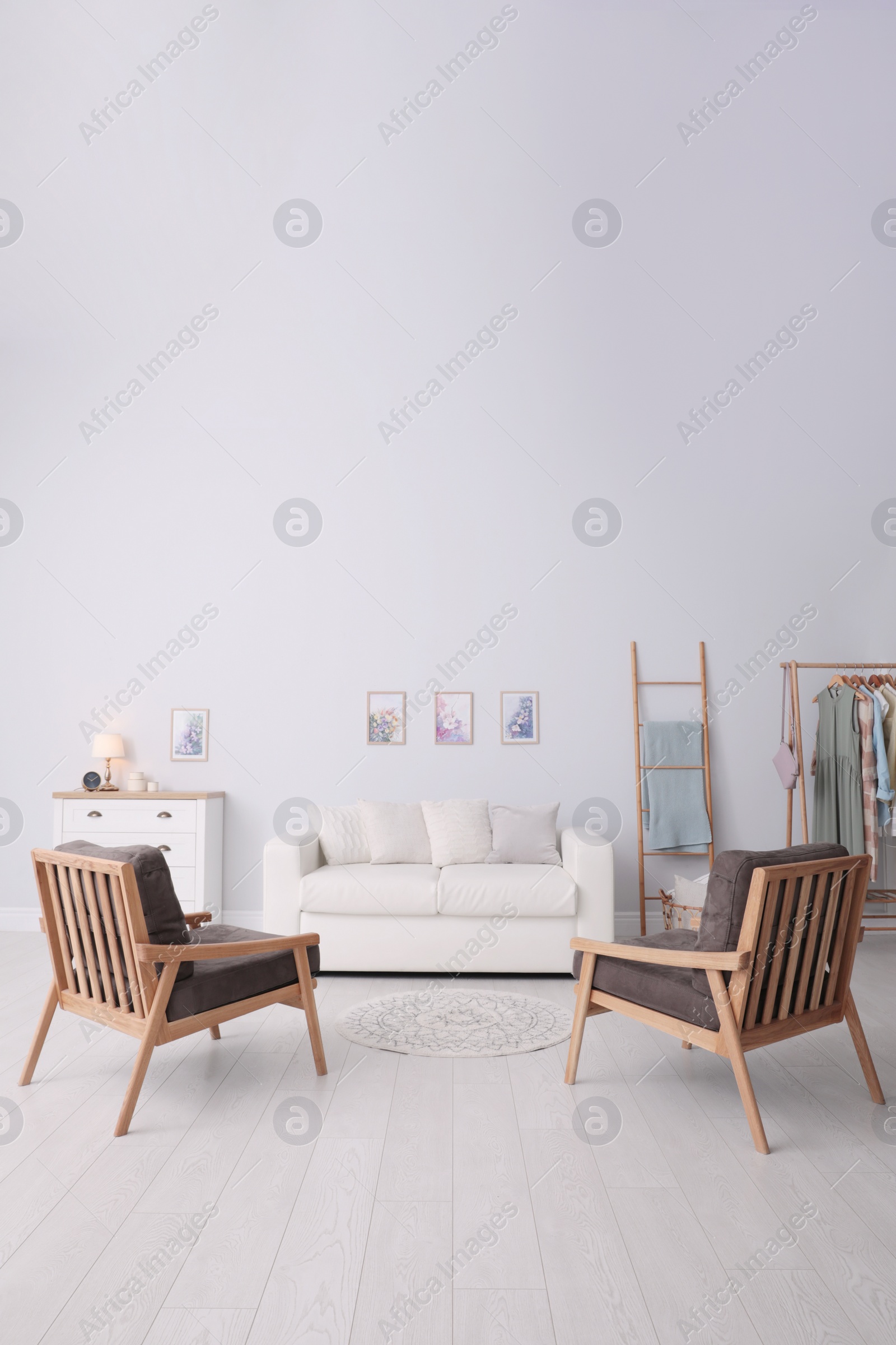 Photo of Modern living room interior with comfortable sofa and armchairs