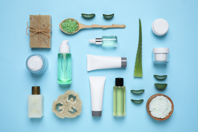 Photo of Flat lay composition with aloe vera and cosmetic products on light blue background