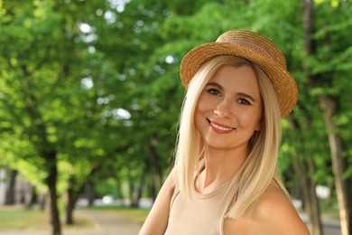 Photo of Portrait of beautiful woman in straw hat outdoors on sunny day