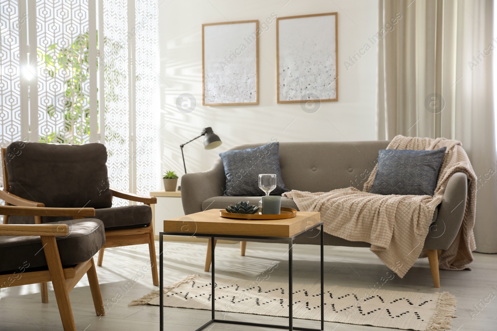 Photo of Modern living room interior with comfortable sofa and armchairs