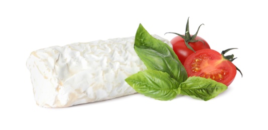 Delicious fresh goat cheese with basil and cherry tomatoes on white background