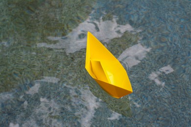 Photo of Beautiful yellow paper boat on water outdoors