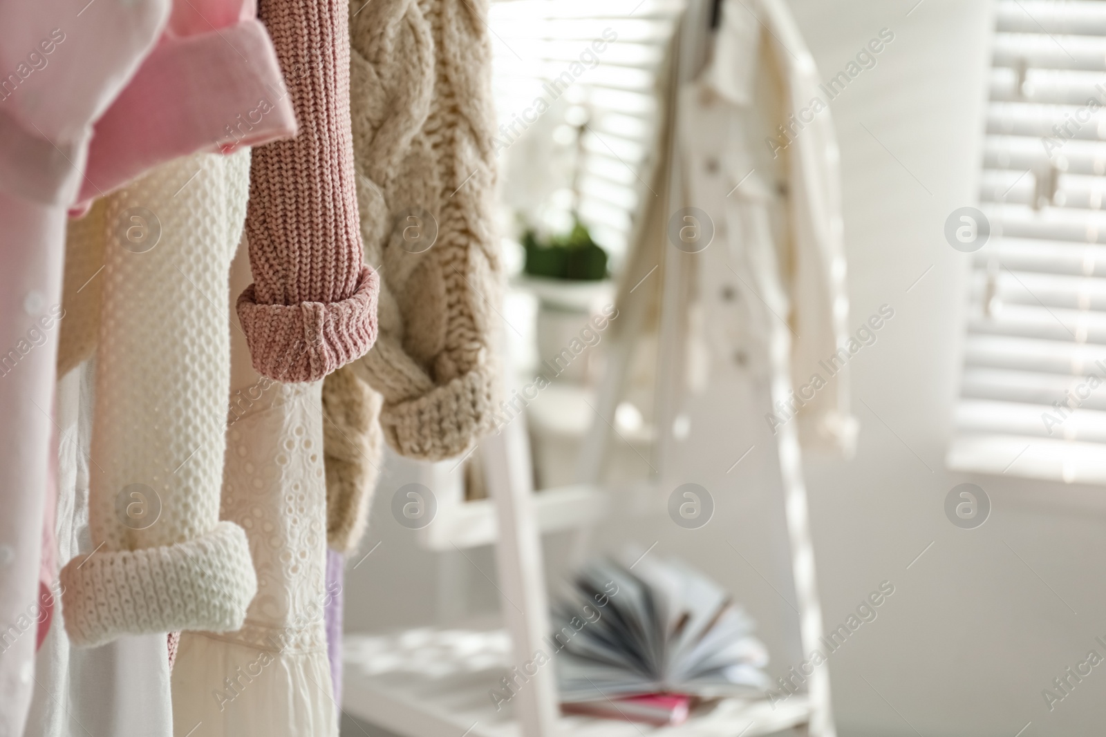 Photo of Rack with stylish women's clothes indoors, space for text. Interior design