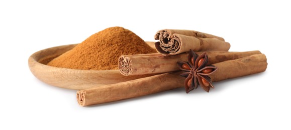 Dry aromatic cinnamon sticks, powder and anise star isolated on white