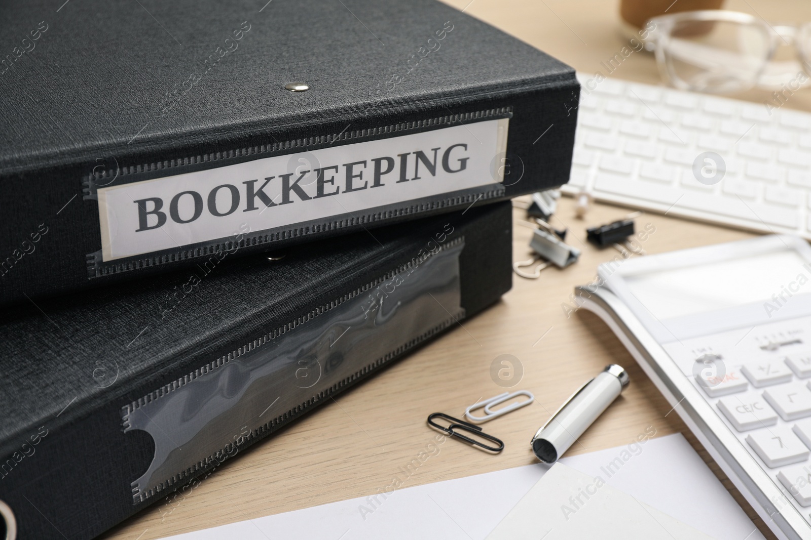 Photo of Bookkeeper's workplace with folders and documents on table