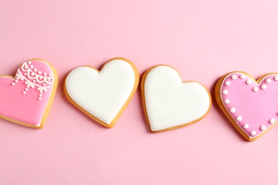 Photo of Decorated heart shaped cookies on color background, top view