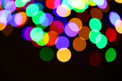 Photo of Beautiful colorful lights on dark background. Bokeh effect