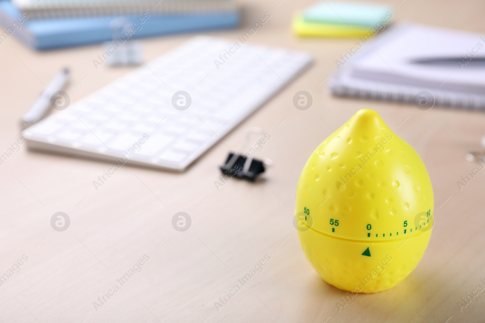 Photo of Kitchen timer in shape of lemon on wooden table, closeup. Space for text