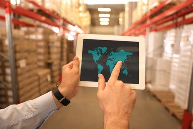 Image of Man with tablet at warehouse, closeup. Wholesale business